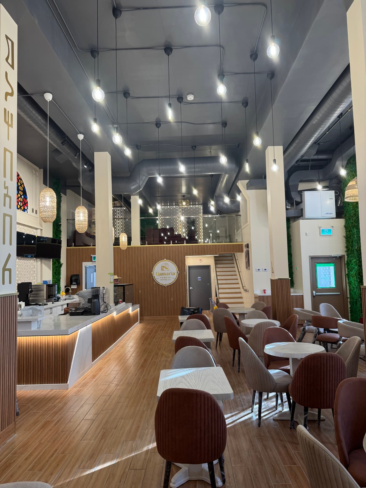Warmly lit commercial café interior with pendant and recessed lighting